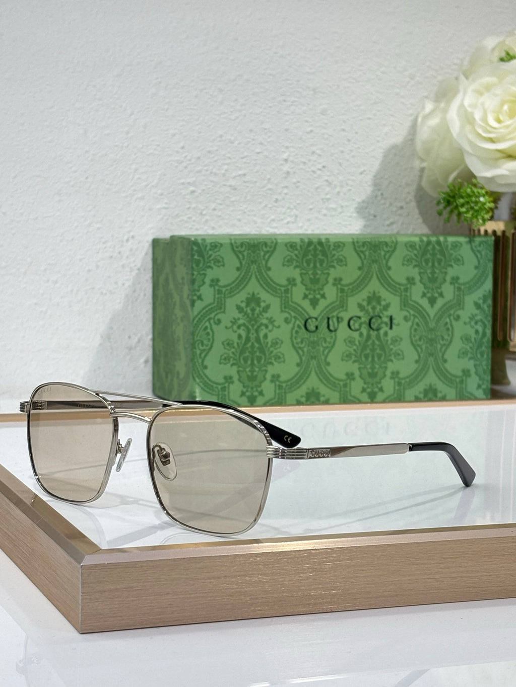 Gucci sunglasses with clear gray lenses and light gold metal frame