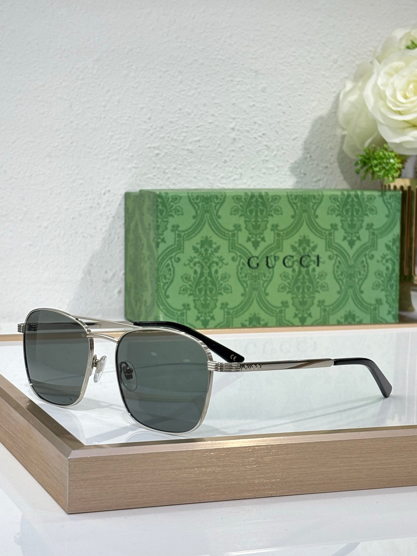Gucci sunglasses with dark lenses and gold-tone metal frame