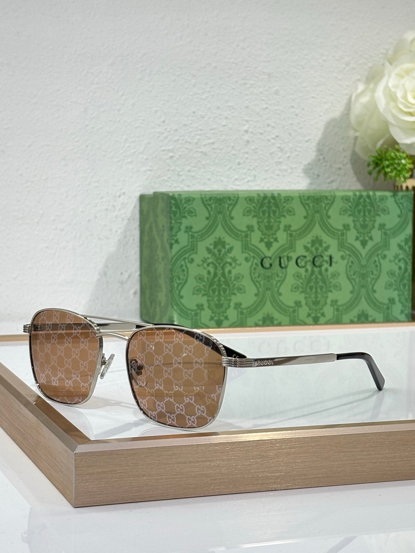 Gucci sunglasses with brown gradient lenses and gold-tone metal frame