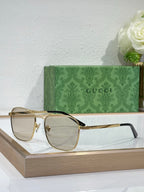 Gucci sunglasses with pale gray lenses and black-accent metal frame
