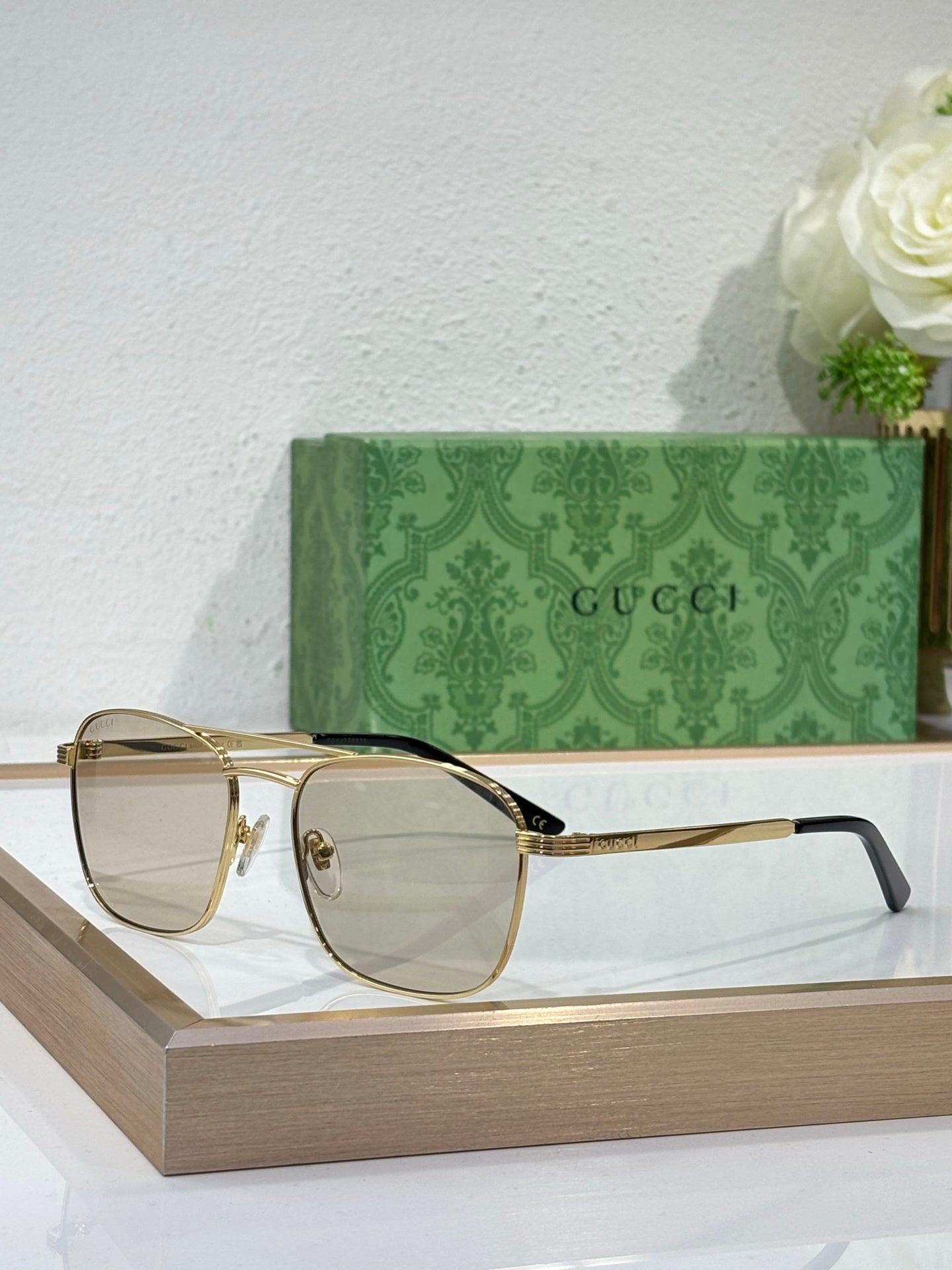 Gucci sunglasses with pale gray lenses and black-accent metal frame