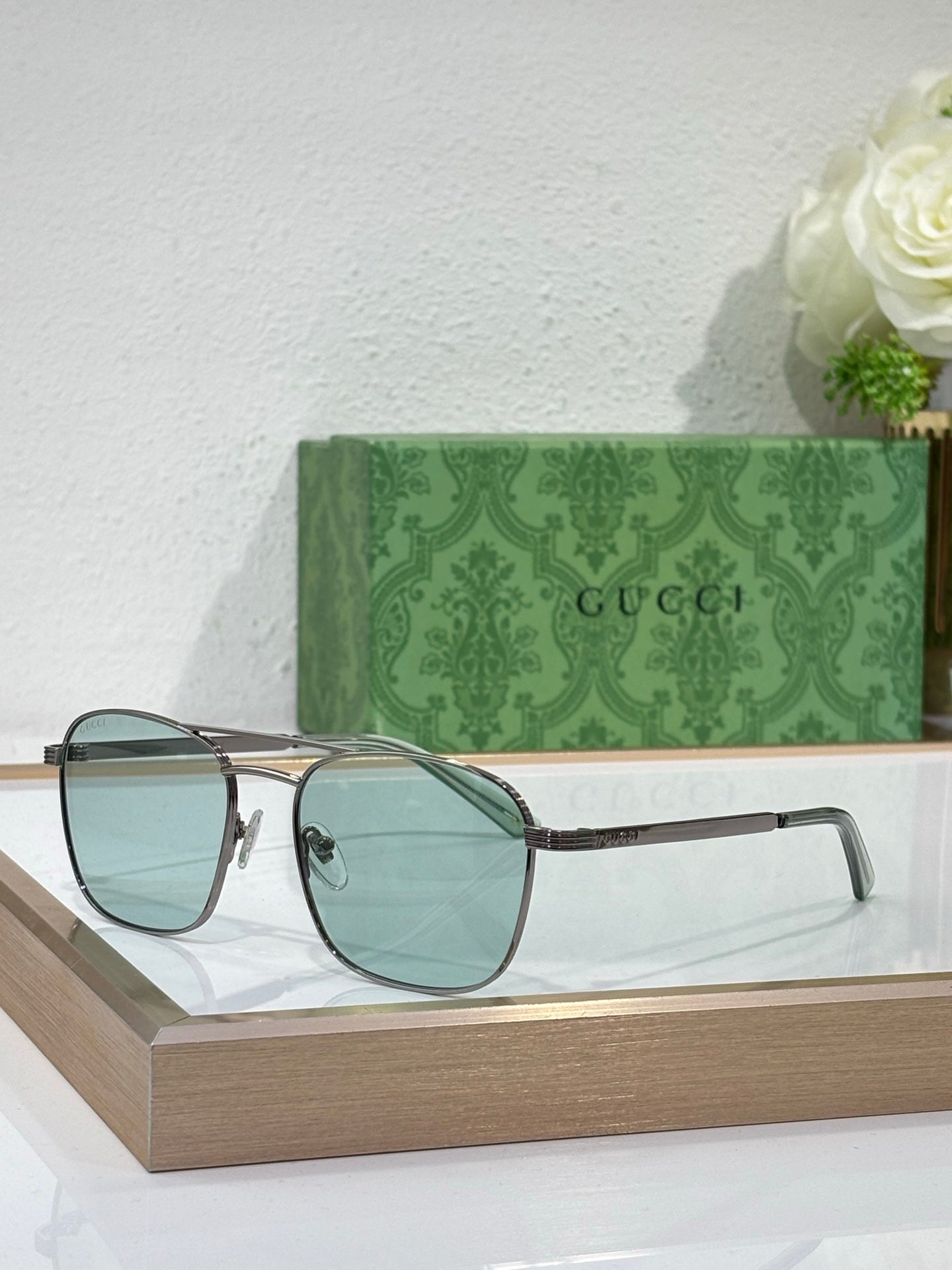 Gucci sunglasses with light blue gradient lenses and silver-tone metal frame