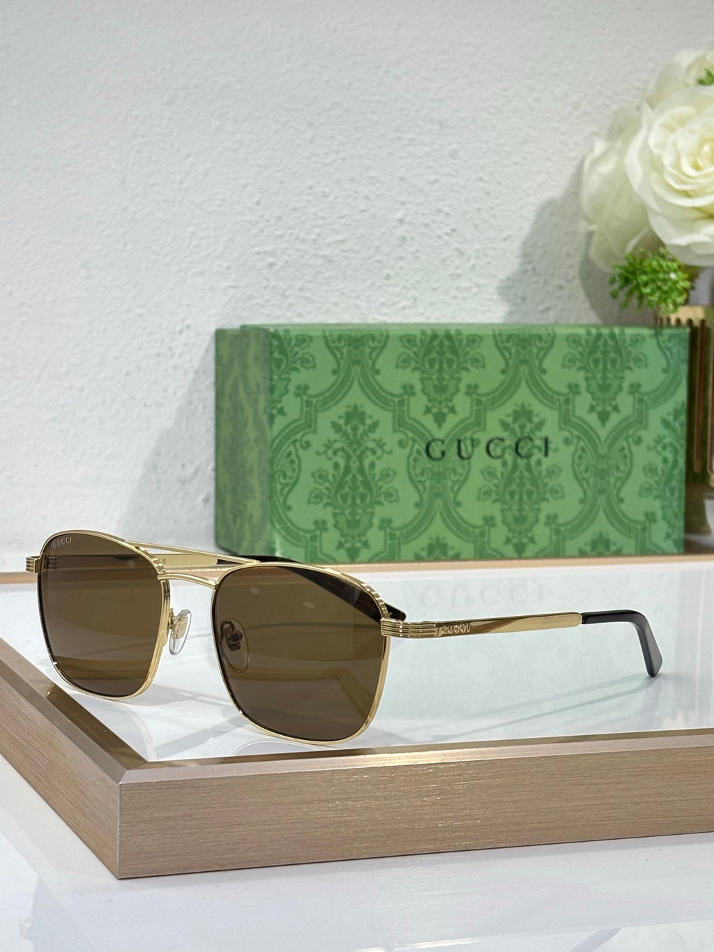 Gucci sunglasses with amber lenses and gold-tone metal frame