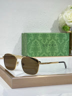 Gucci sunglasses with amber lenses and gold-tone metal frame