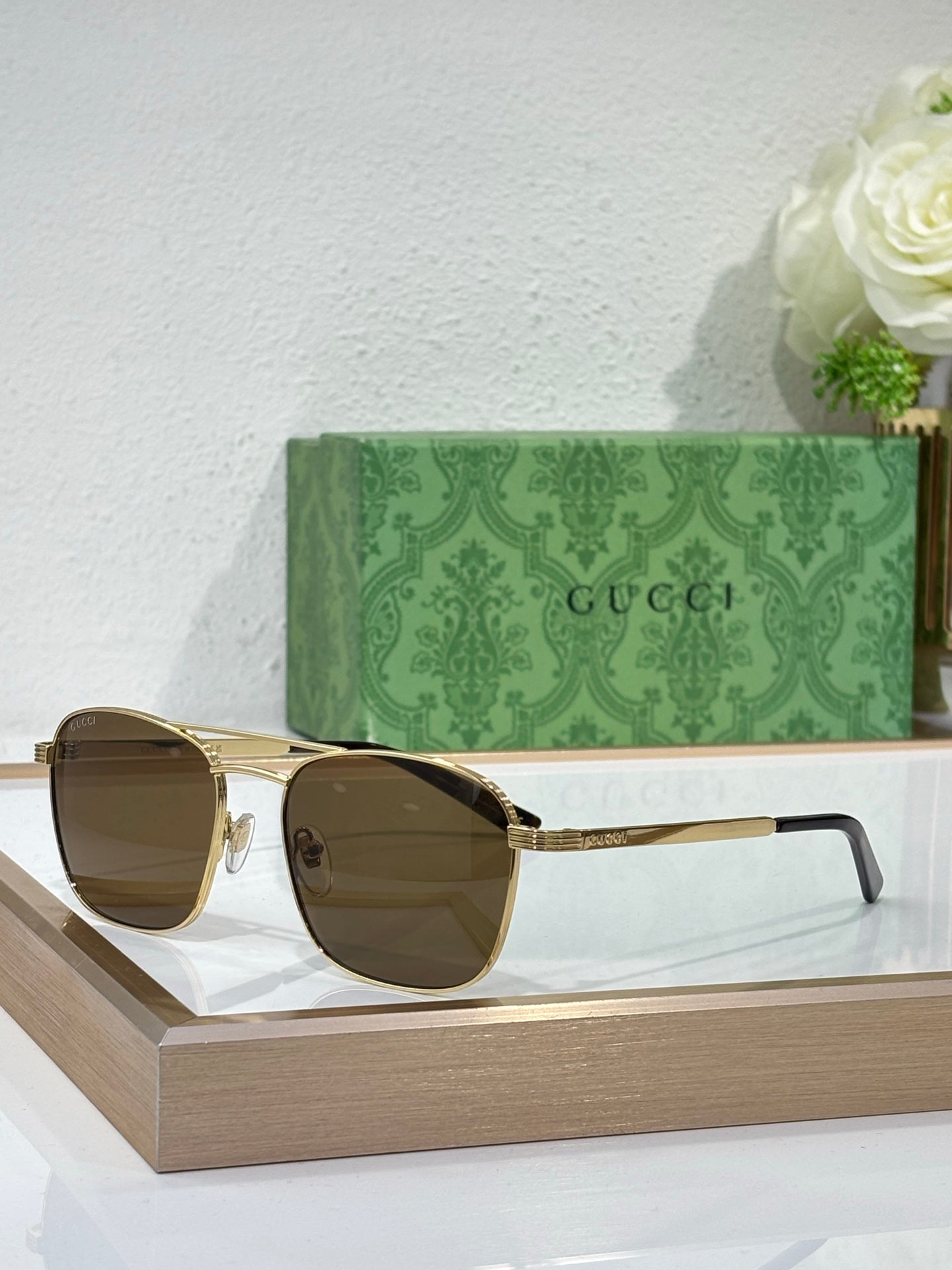 Gucci sunglasses with amber lenses and gold-tone metal frame