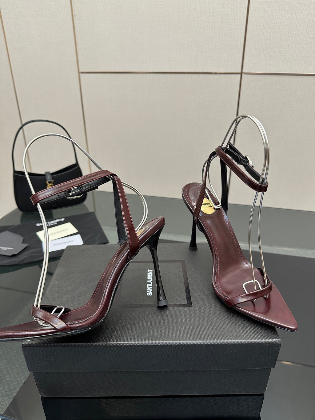Burgundy pointed-toe strappy sandals with thin stiletto heels and slingback straps