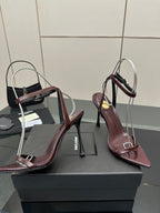 Burgundy pointed-toe strappy sandals with thin stiletto heels and slingback straps