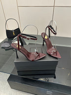 Burgundy strappy high-heel sandals on display, pointed toes and thin stiletto heels