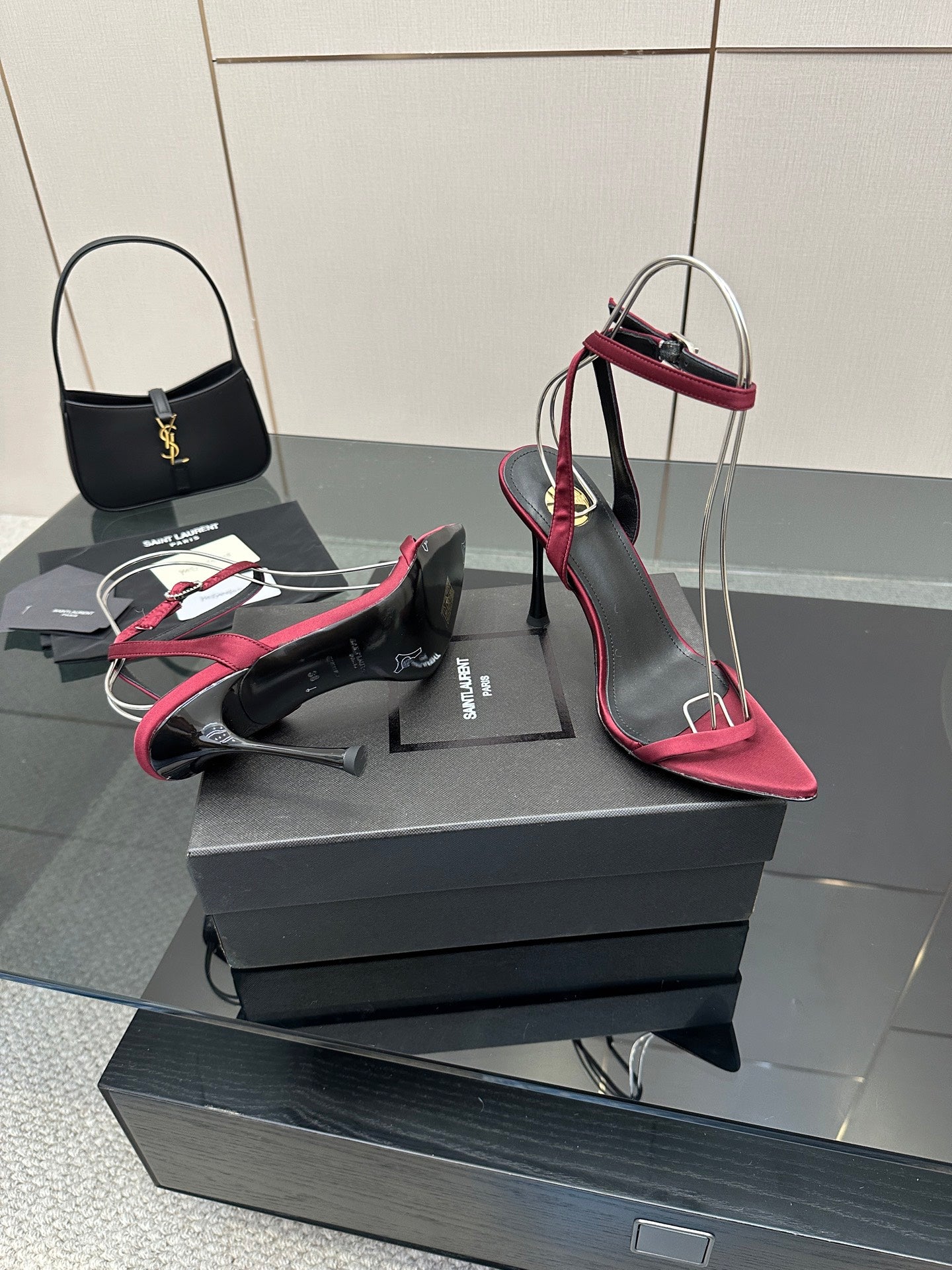 Pink strappy stiletto sandals with black straps and silver wire arch on platform