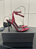Pink strappy stiletto sandals with thin high heel, black lining, silver wire handle