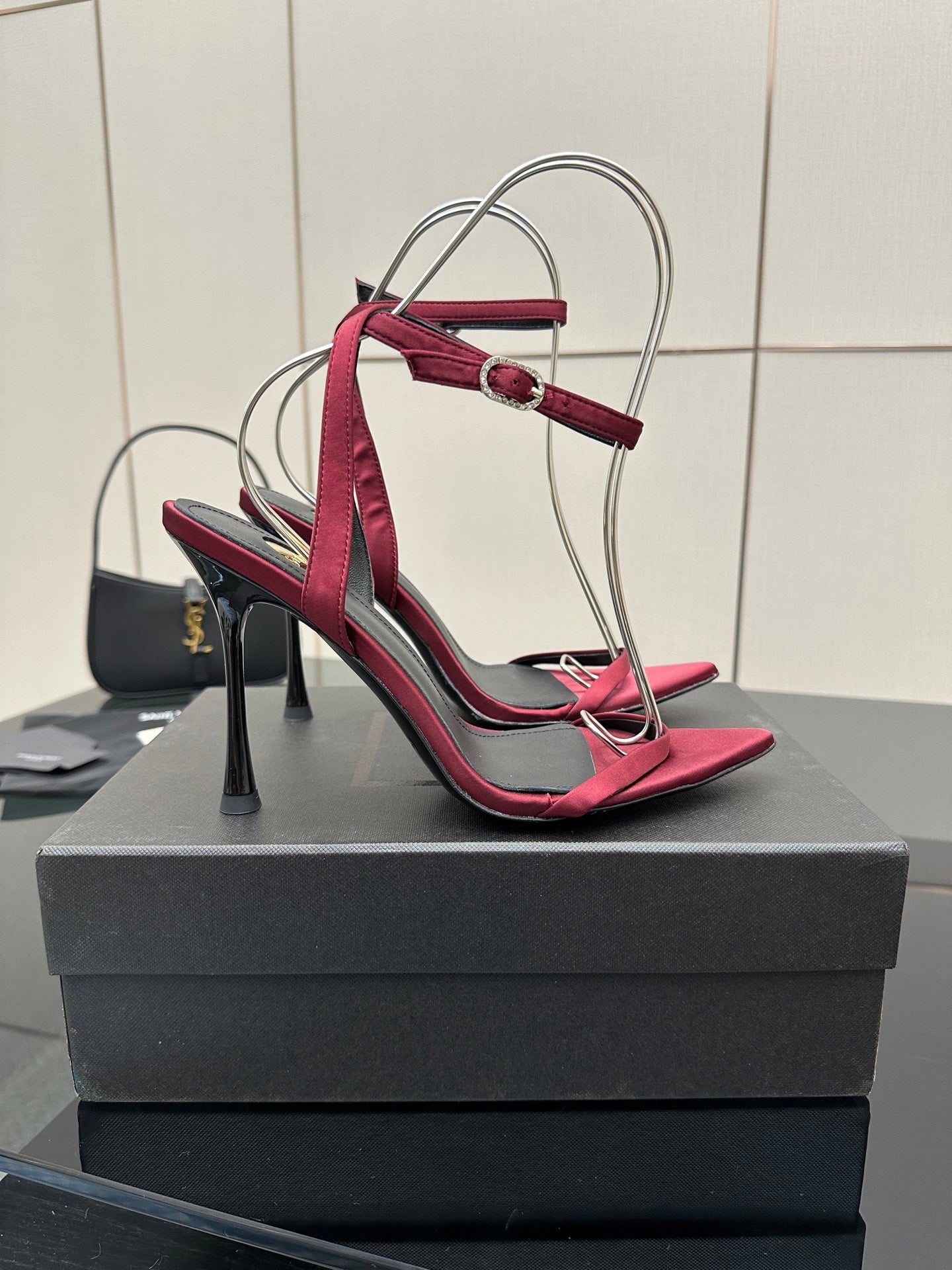 Pink strappy stiletto sandals with thin high heel, black lining, silver wire handle