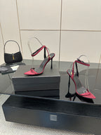 Pink stiletto sandals with black heel, silver wire arch straps, open-toe design