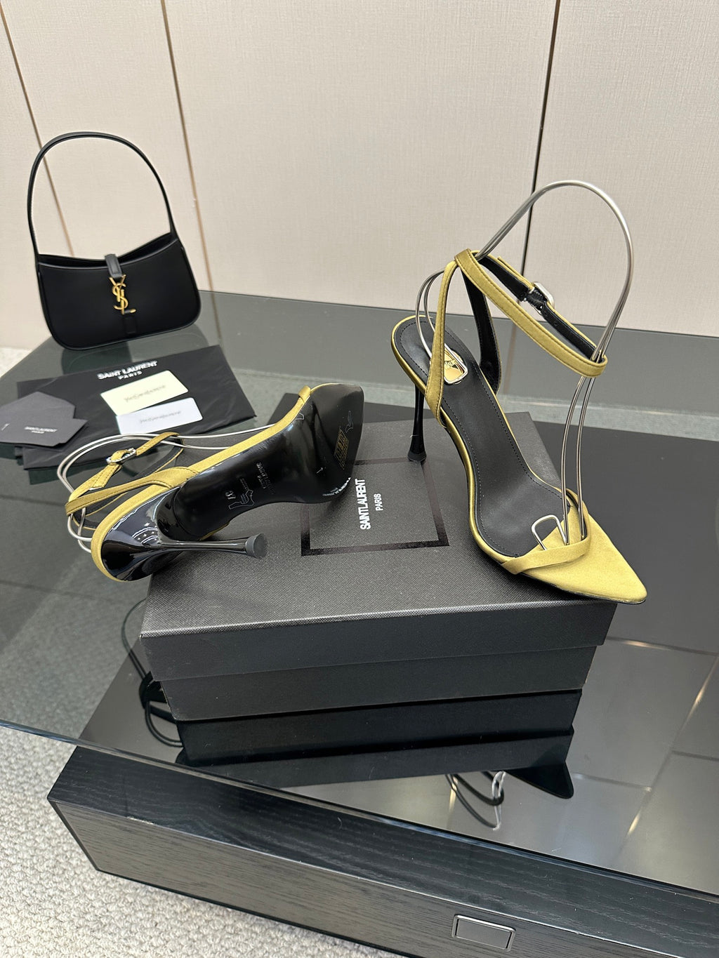 Women’s two-tone heeled sandals: black upper with yellow straps and pointed toe.