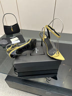 Women’s two-tone heeled sandals: black upper with yellow straps and pointed toe.