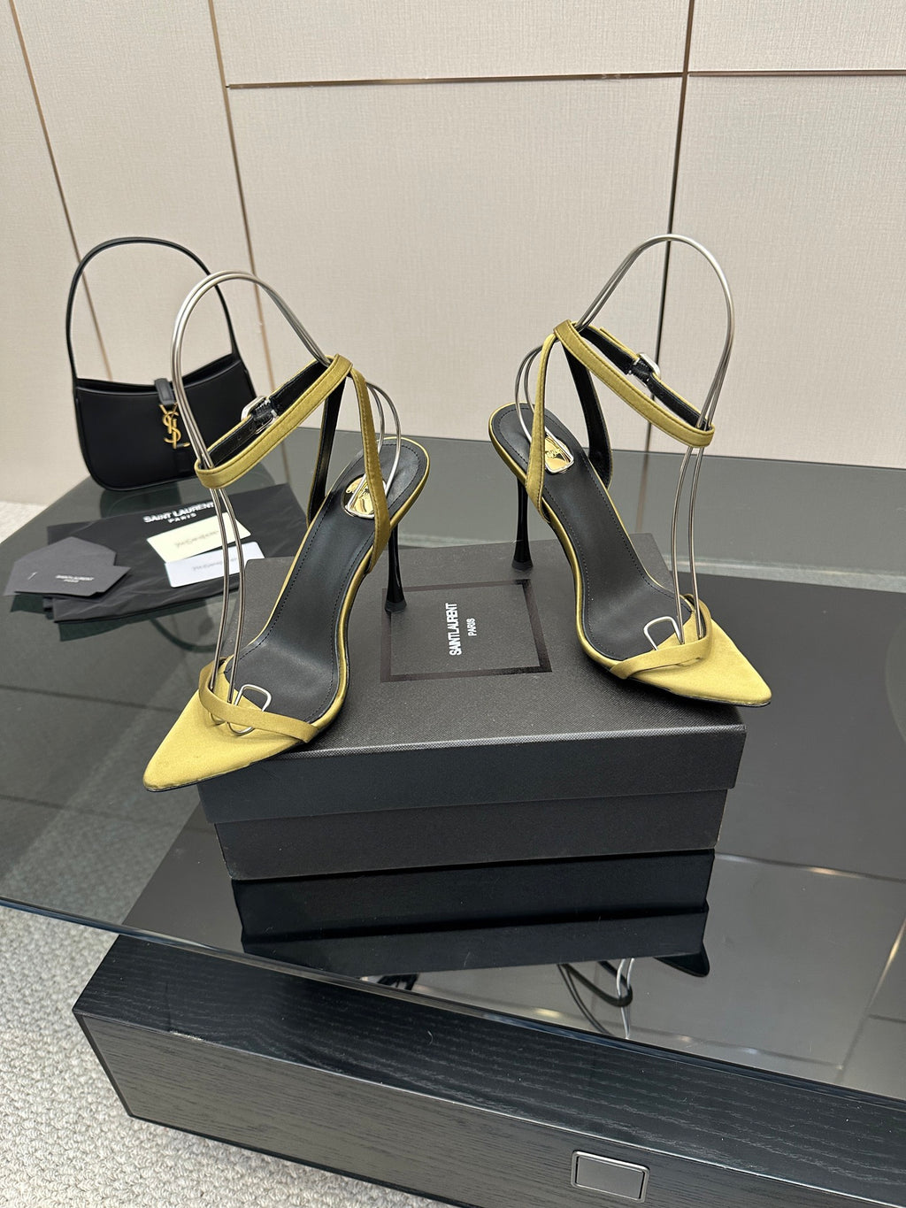 Women’s heeled sandals with yellow toe and strap, black upper, thin stiletto heel.