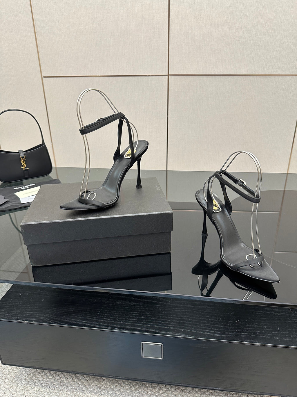Black women’s high-heel sandals with ankle strap and pointed toe, close angle