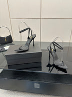 Black women’s high-heel sandals with ankle strap and pointed toe, close angle