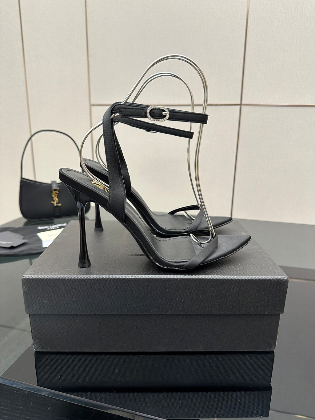 Black women’s high-heel sandals with T-strap and slim heel, angled view