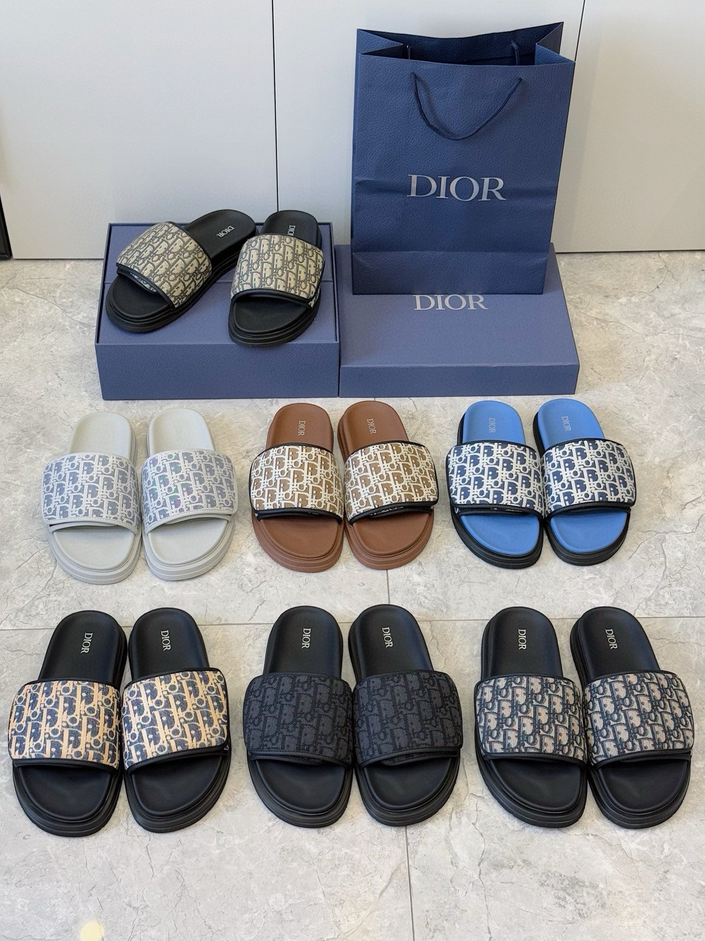Dior slide sandals assortment, assorted Oblique prints and colors arranged together