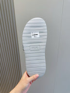 Dior slide sandal outsole, ribbed light sole with Dior branding, viewed from bottom
