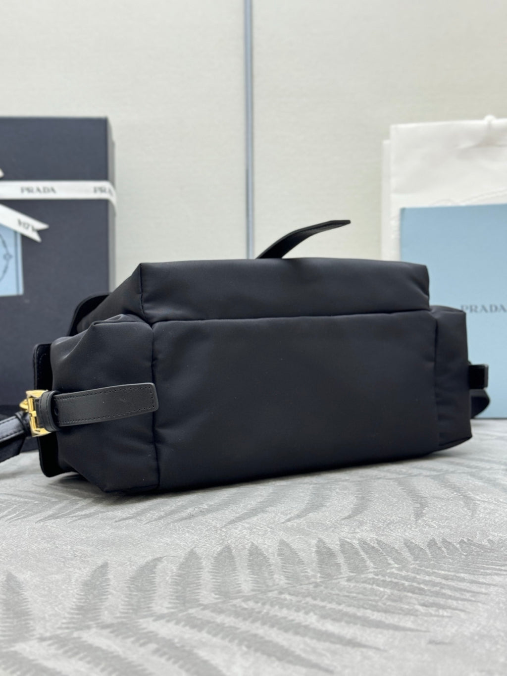 Prada black nylon bag with structured sides and rear handle, padded top section