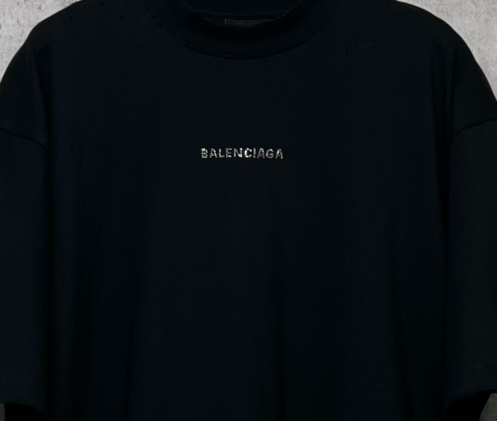 Balenciaga black crewneck T-shirt close-up of small rhinestone chest logo