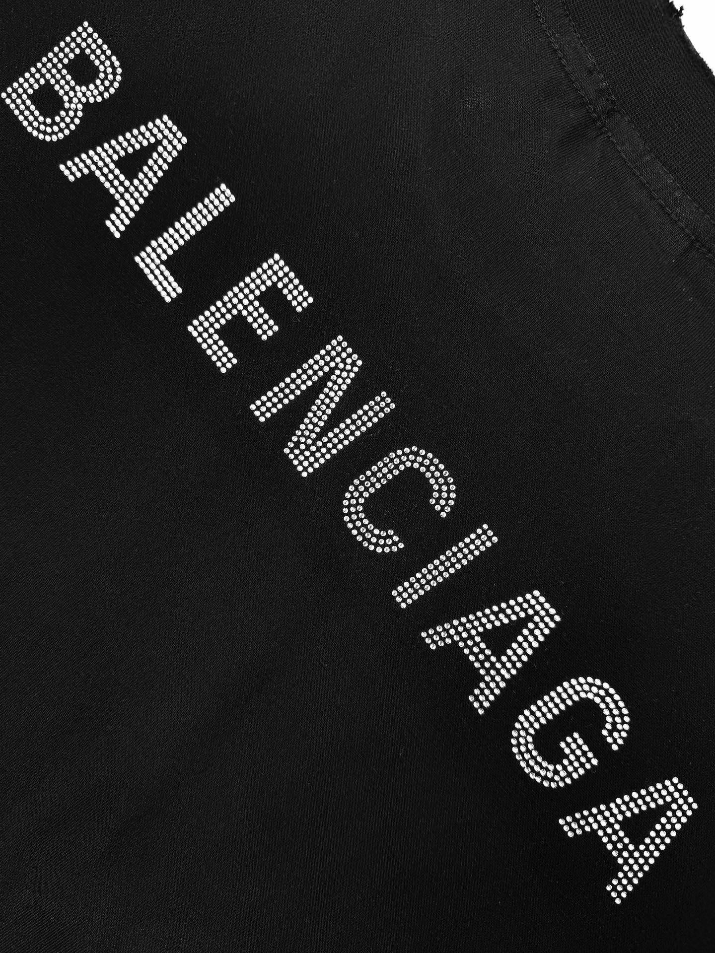 Balenciaga rhinestone lettering detail on a black T-shirt sleeve