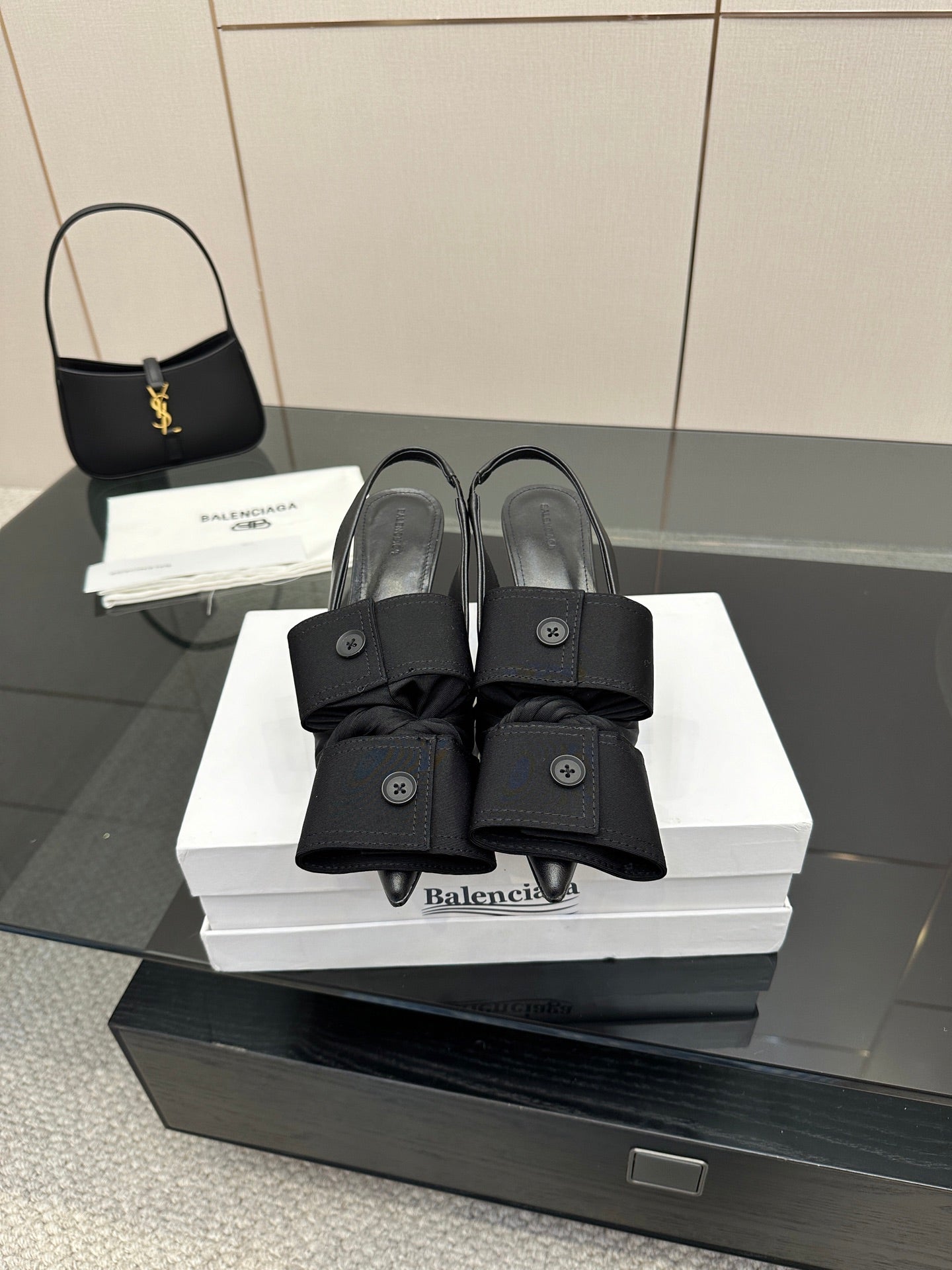 Black mules with toe strap and low block heel, on white Balenciaga box
