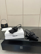 Black mules with toe strap and low block heel, on white Balenciaga box