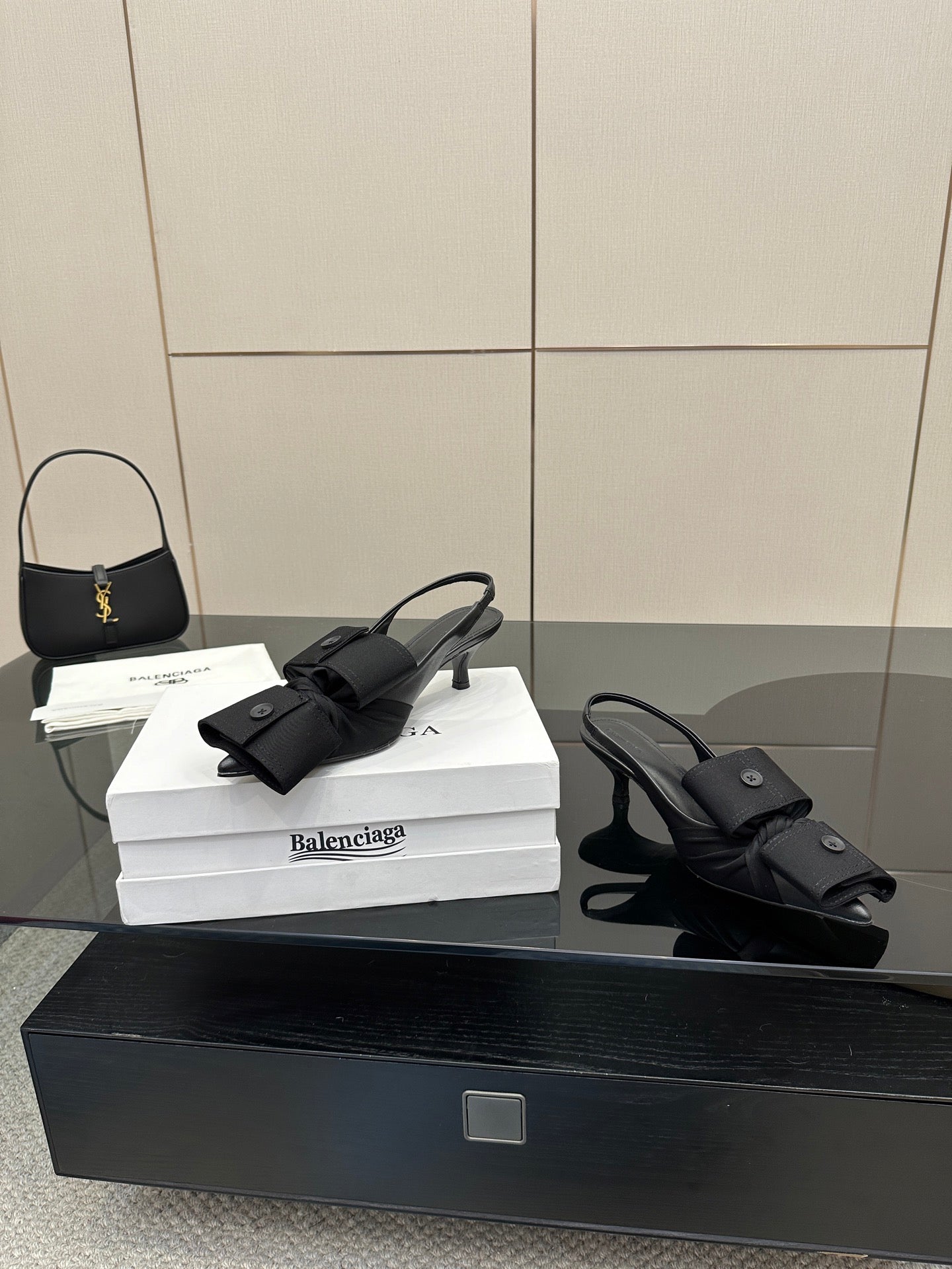 Black mules with toe strap and low block heel, on white Balenciaga box