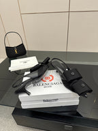 Black mules with toe and ankle straps and low block heel, on stacked boxes