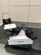 Black mules with buckled straps and low block heel, on white Balenciaga box