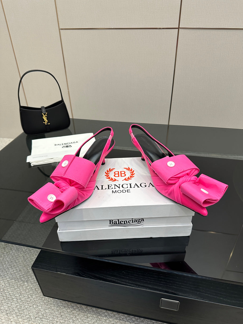 Pair of pink bow mule sandals with stiletto heel and wide bow detail