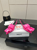 Pair of pink bow mule sandals with stiletto heel and wide bow detail