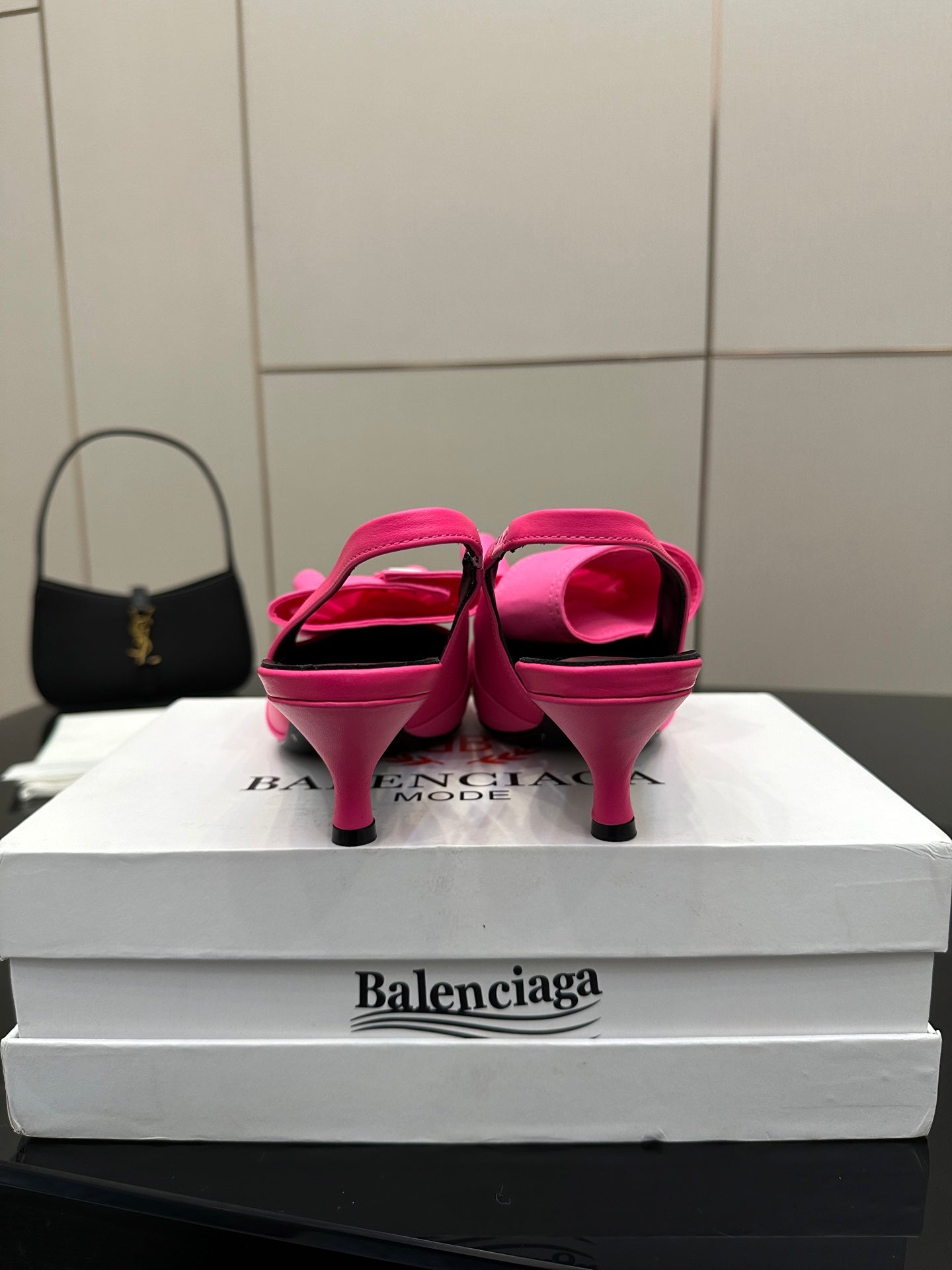 Pink mule sandals from back view, stiletto heel and bow straps
