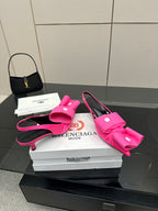 Pink bow mule sandals with stiletto heel, rounded toe and sling-back strap