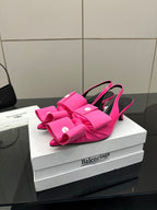 Pink bow mule sandals with stiletto heel and front bow straps