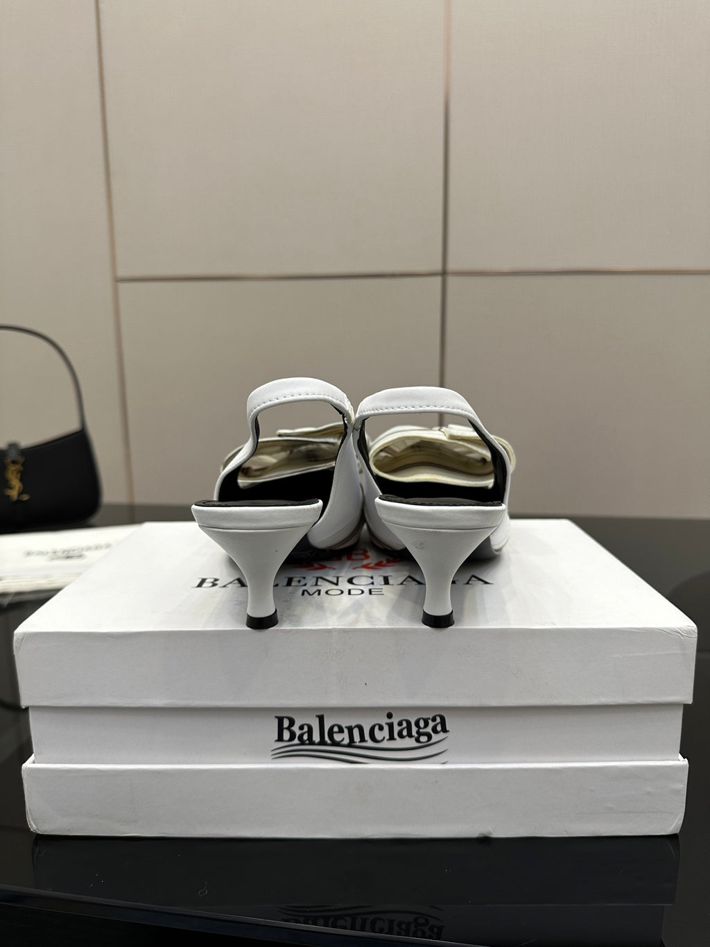 White Balenciaga women's heeled slingback sandals shown from the back