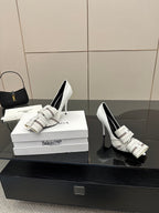 Balenciaga women\u2019s white heeled mules with striped straps and buckle, side-by-side