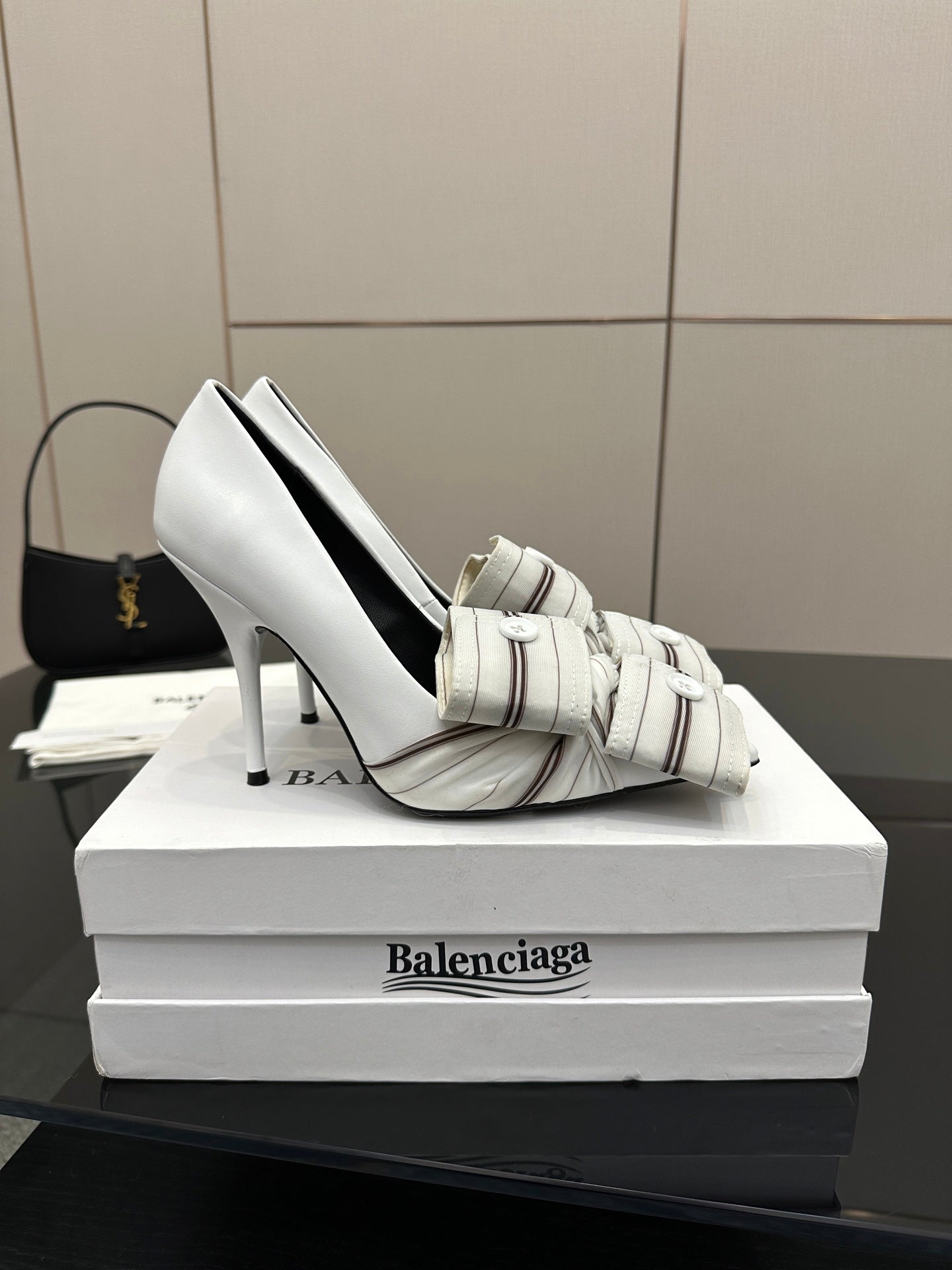 Balenciaga women\u2019s white heeled mule shoe with striped strap and buckle, side view