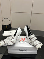 Balenciaga women\u2019s pointed-toe heeled mules with striped strap and buckle, white