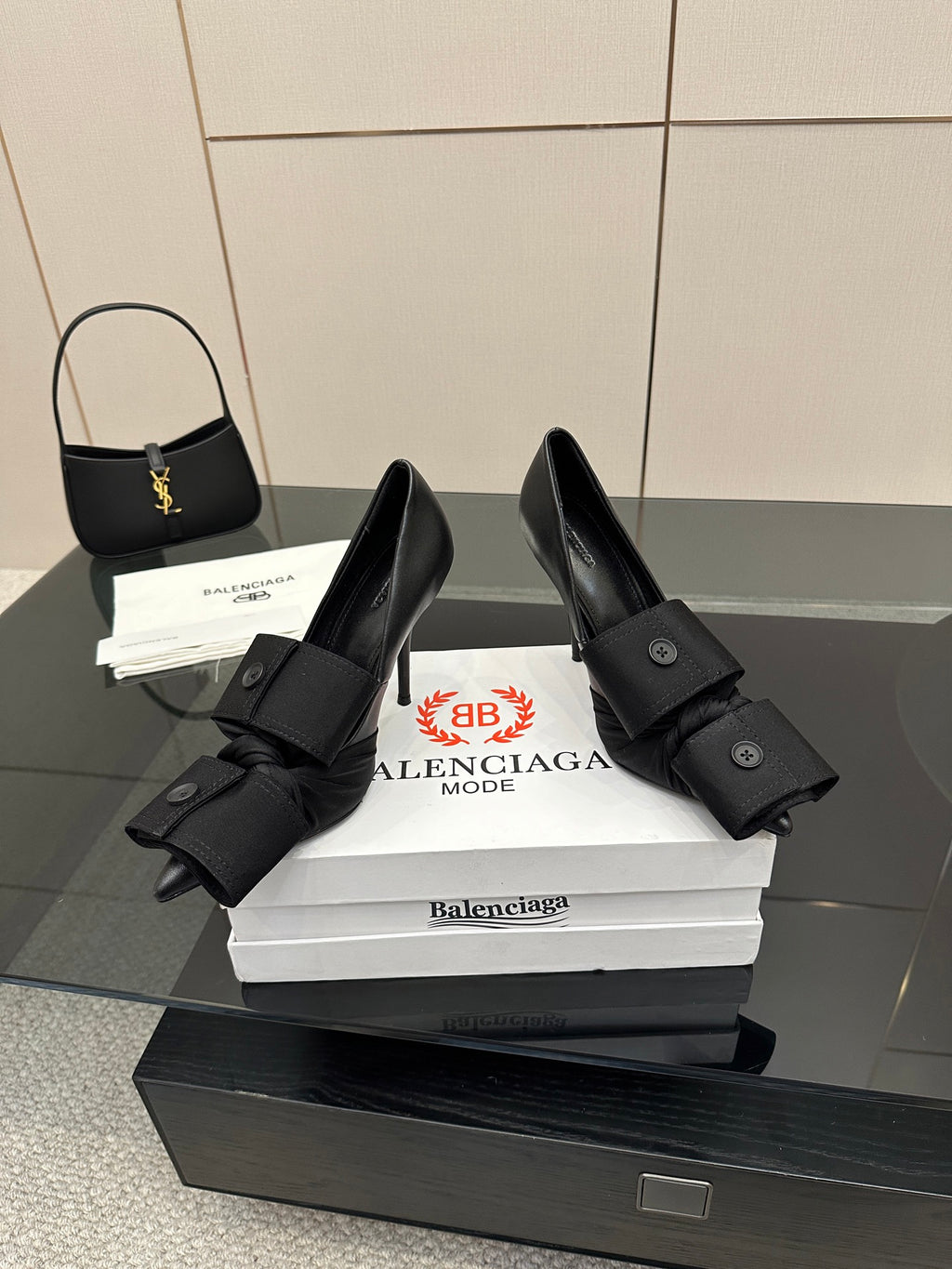 Pair of black pointed-toe high heel slingback shoes with wrapped ankle straps