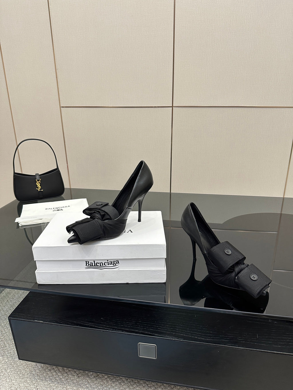 Black pointed-toe high heel slingback shoes with ankle wrap straps and button closures