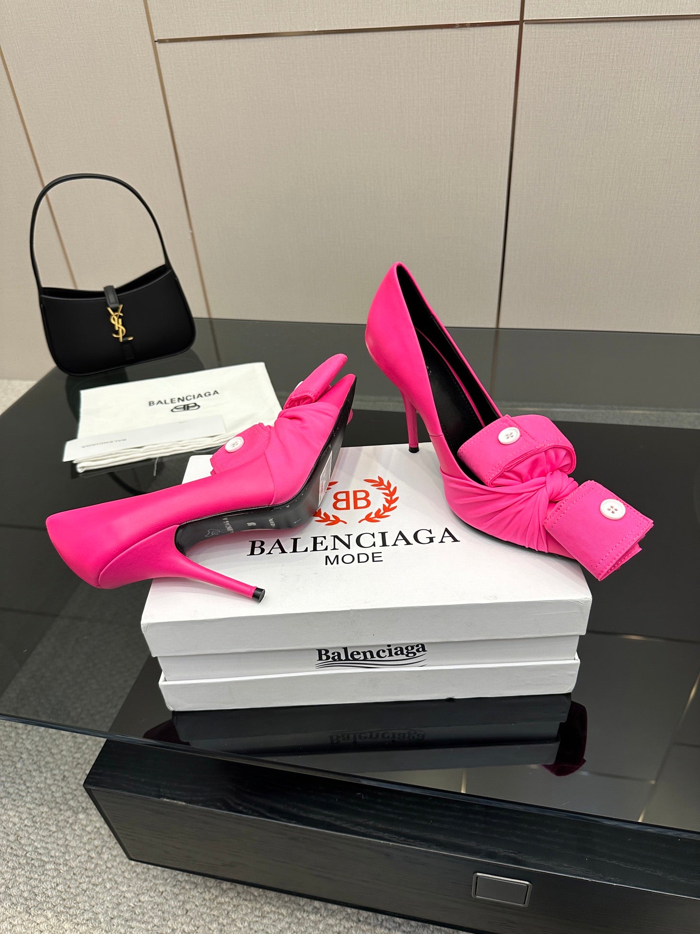 Pink stiletto heels with knotted bow detail and pointed toe