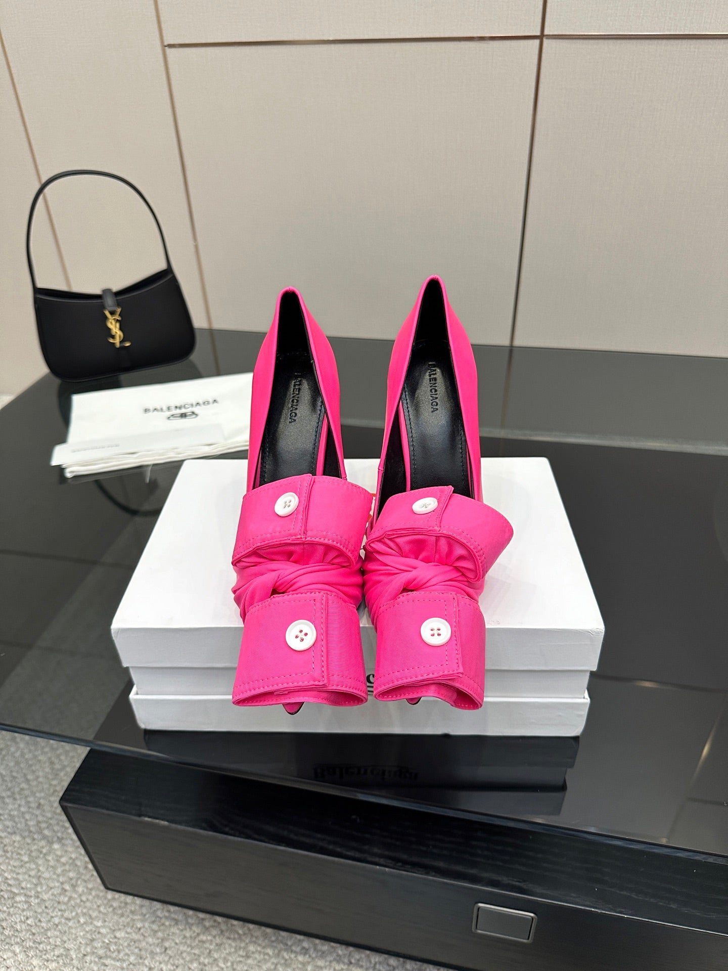 Pink high-heel shoes with knotted bow detailing and round button accents
