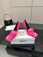 Pair of pink high heels with knotted bow straps and slender stiletto heels