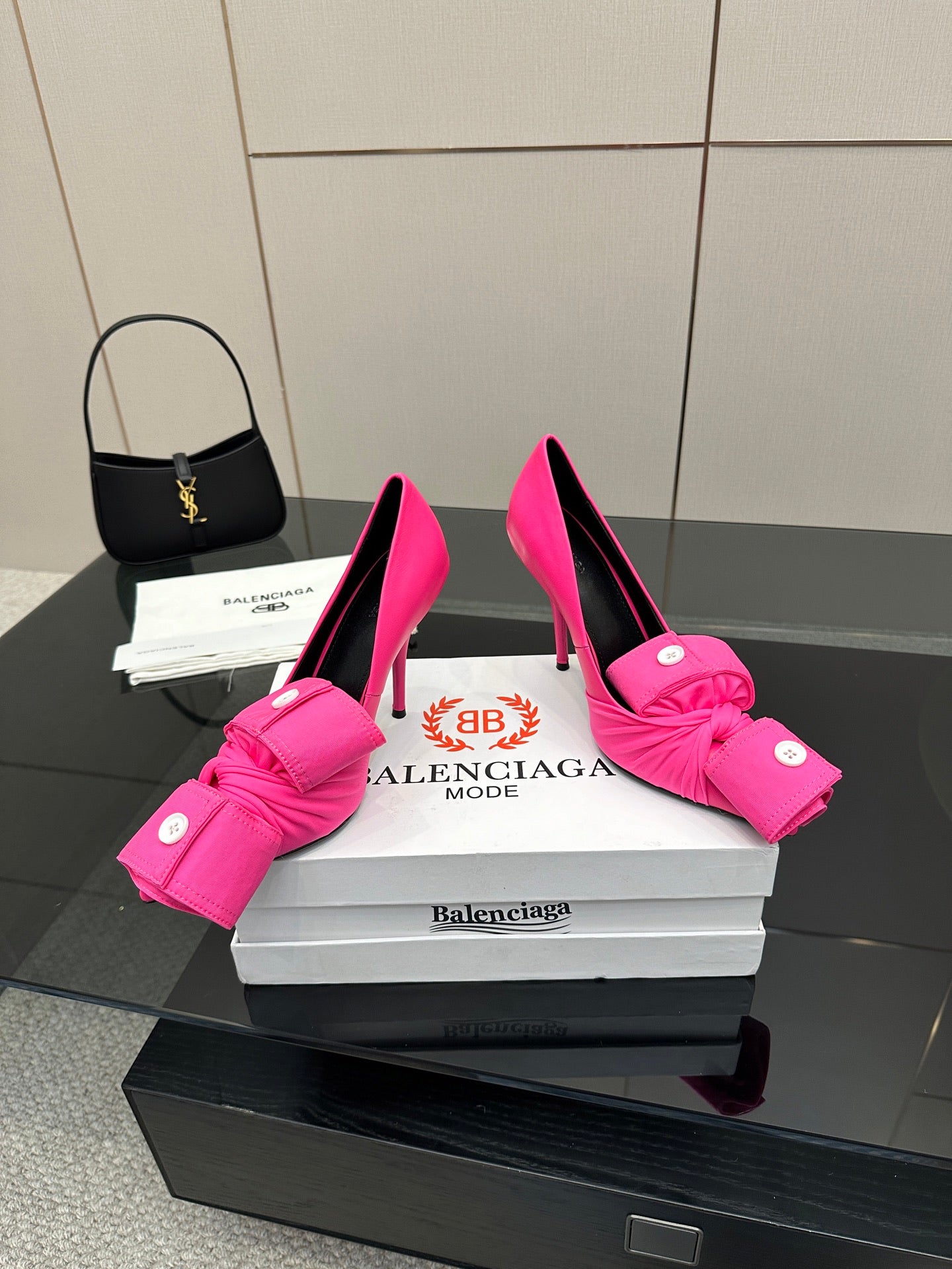 Pair of pink high heels with knotted bow straps and slender stiletto heels