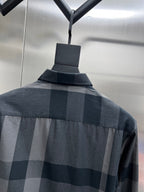 Long-sleeve button-up shirt back with dark-and-light plaid pattern and collar