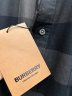 Burberry shirt fabric with tan hang tag and button, dark gray and navy check