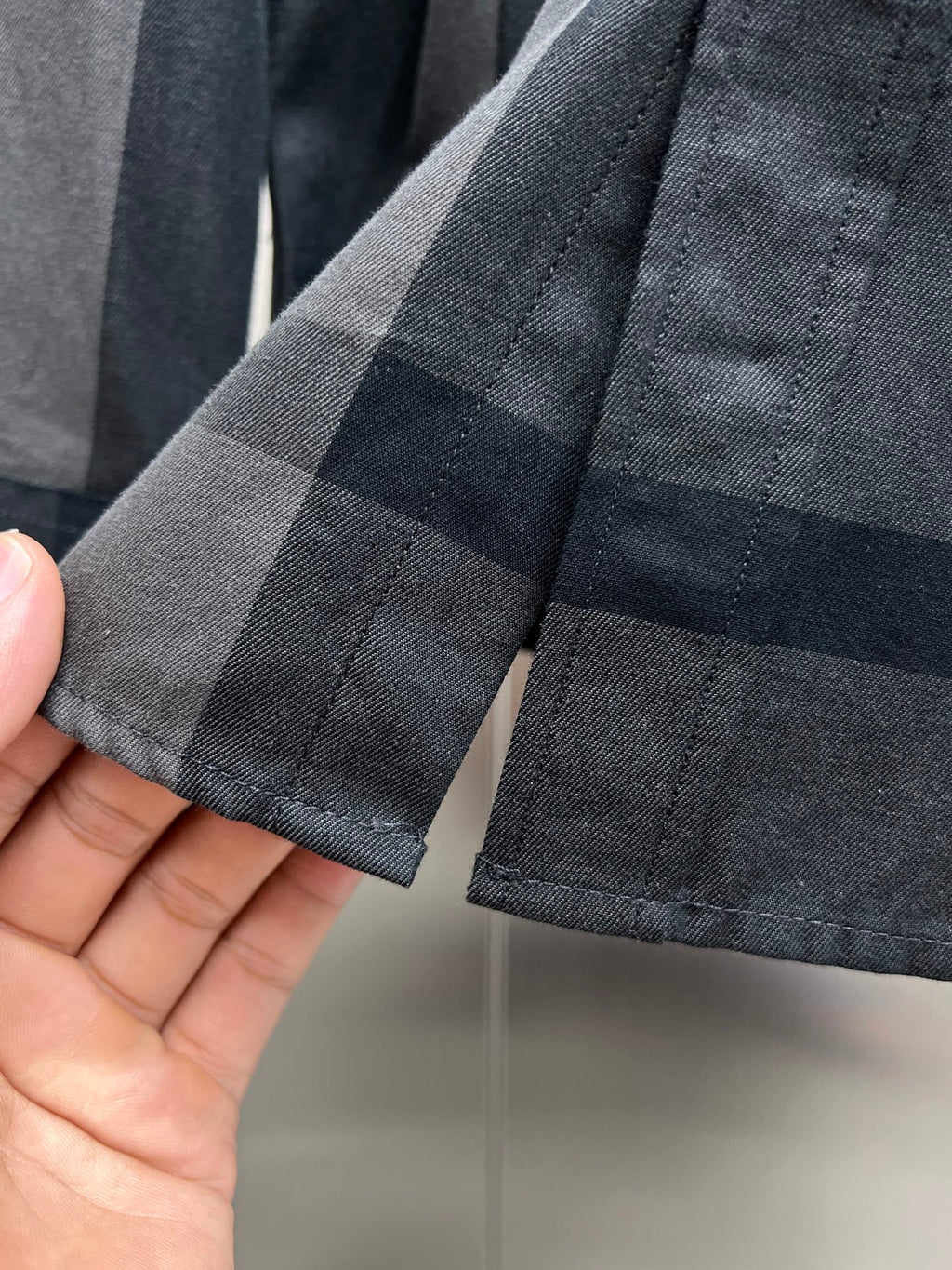 Burberry plaid shirt cuff hem with buttonhole detail, dark gray and navy check